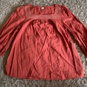 Orange blouse with white detail